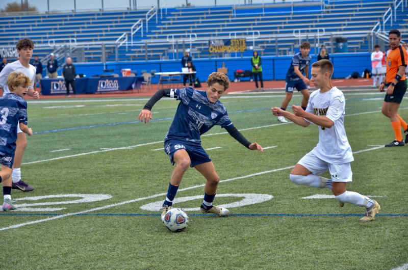 Sussex Academy senior Liam Stegall tries to clear himself for a shot or a cross as he approaches the box.