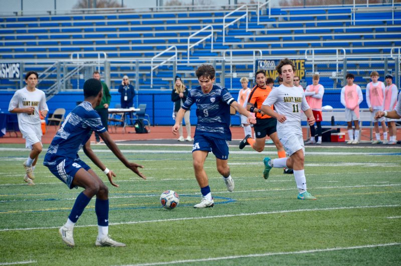 Seahawks senior George Sapna loads the cannon for a shot with Jesse Jean-Louis offering his services.