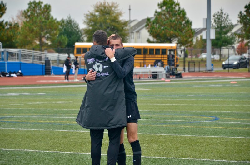 Sussex Academy coach Kyle Wheatley comforts Austin Taylor.