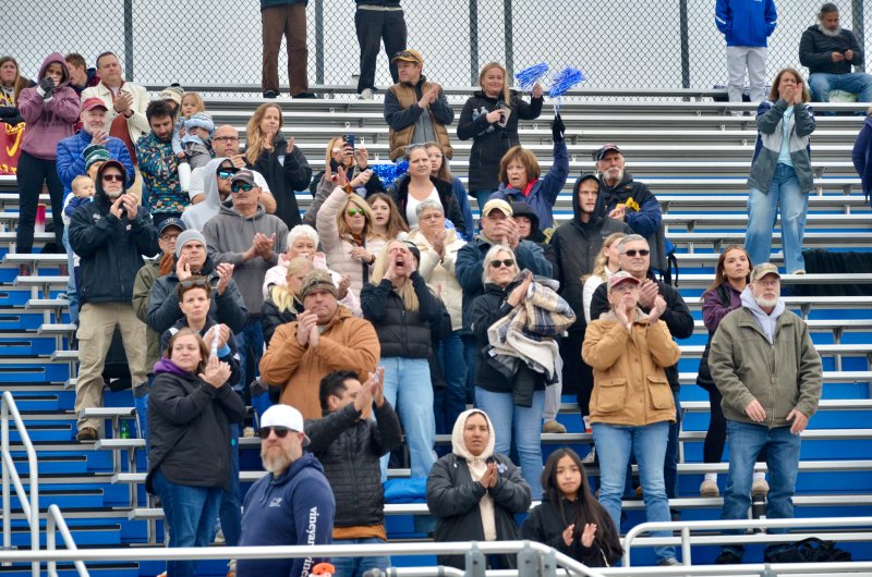 Sussex Academy parents and fans cheer on the boys following the game.
