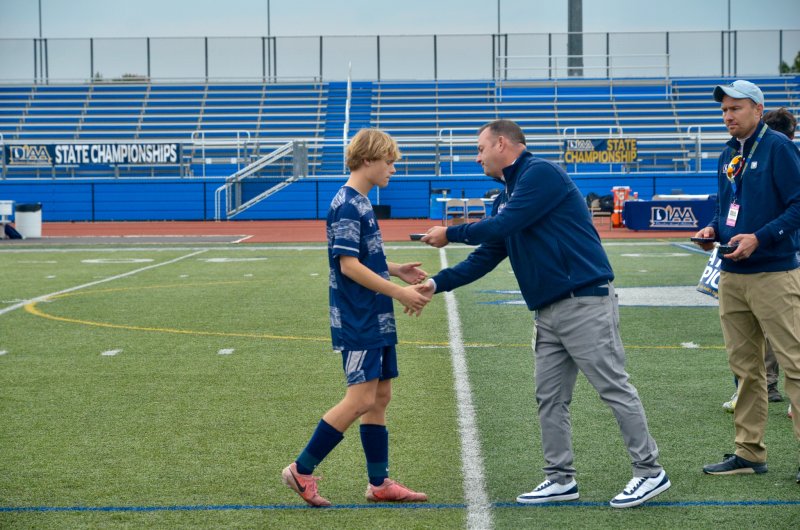 Sussex Academy senior Noah Benz receives his silver medal.