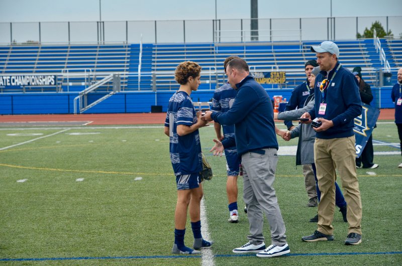 Sussex Academy senior Liam Stegall finally stopped moving on the pitch to collect his medal.