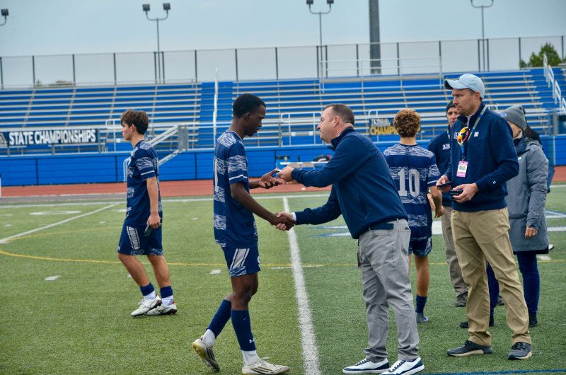 Seahawks senior Jesse Jean-Louis shakes hands as he gets his silver medal.