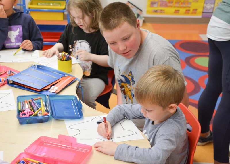 Love Creek Elementary student Landon Thomas starts the design of his monster with a little help from Lincoln Rogerson of Beacon MS.