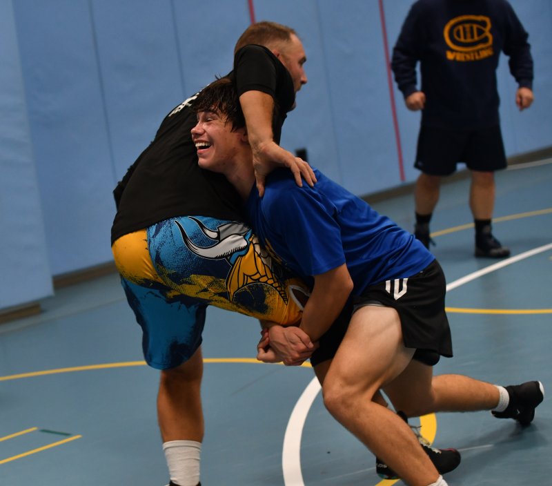 State champion Nick Walker gets a single leg on coach Jeff Hudson.