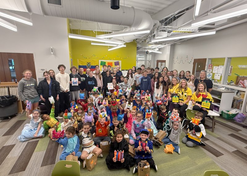Milton Elementary kindergarten students show off their monsters created by the Mariner AVID eighth-graders.