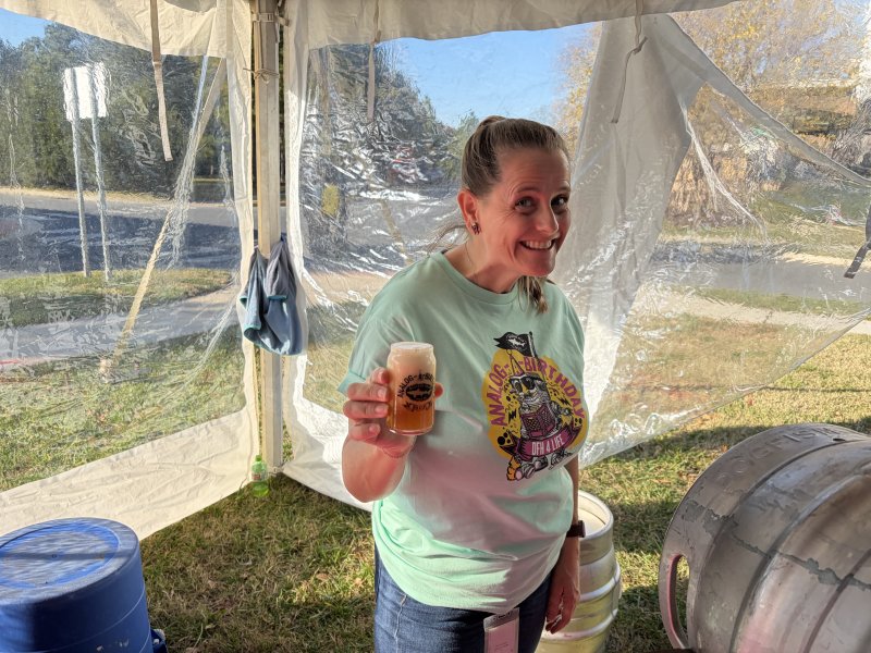 Diane Kaufmann holds up a glass of Dogfish’s beer Succulent Chinese Meal.