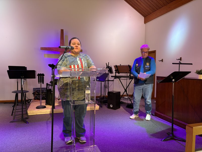 Milton Lions Club members Regina and Brenda Coverdale read the names of honored veterans.