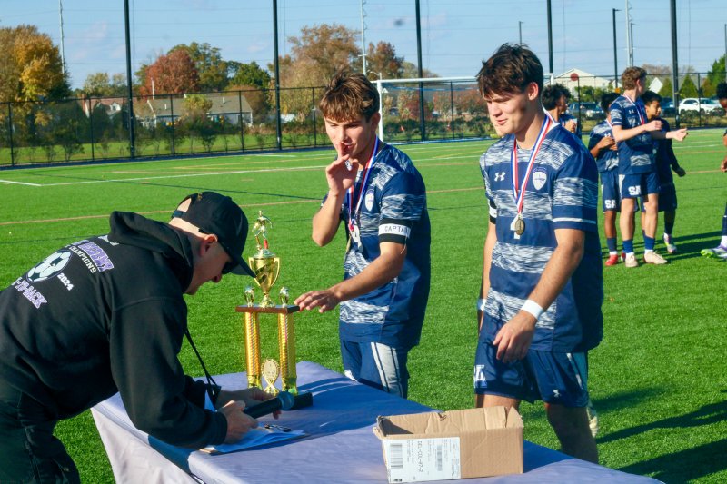 Sussex Academy senior George Sapna keeps it quiet as he and Ben Steimel collect the trophy.