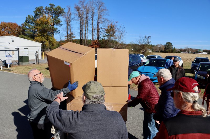 A large number of Clothing Our Kids volunteers help move the boxes, making the job go quickly.