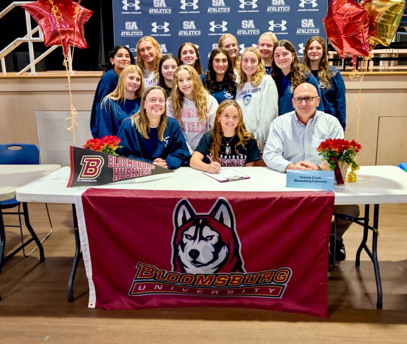 Seahawks senior Victoria Evans is joined by coaches Stephanie Hartsoe and Tom Martiner by her side. Supporting her in back are Camila Figueroa, Catherine Elder, Samantha Petty, Paige Blaine, Eliza Evans, Gretchen Maughan, Kimi Langroudi, Anna Mumford, Emi Obertubbesing, Caitlin Perchiniak, Madeline Perchiniak and Kendall Rhodes.