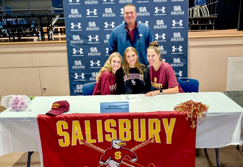 Sussex Academy senior Ryan Lowe smiles with her sister Quinn and mom Angie by her side. Her dad Wyatt proudly standing behind his daughter.
