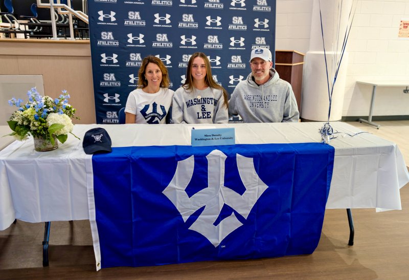 Seahawks senior Shea Danahy signs on to play lacrosse at Washington & Lee with her mom Brittany and dad Kevin next to her.