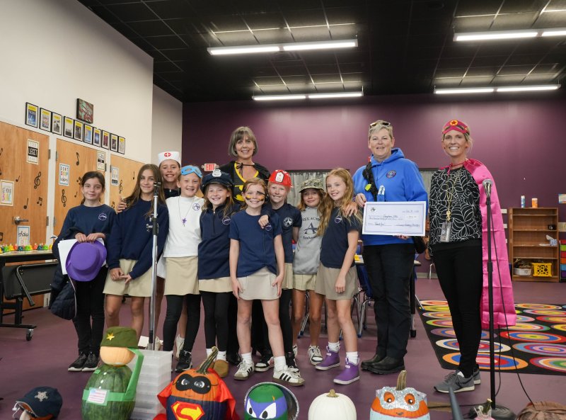 At Sussex Academy’s Halloween Community Hero Day, Dean of Elementary Connie Hendricks, standing back left, is named the winner of the faculty pumpkin-decorating contest. The contest raised $335, which was donated to Georgetown EMS. Standing in back are (l-r) Hendricks; Captain Deanna Loeb, NREMT and FTP, Georgetown EMS; and school counselor Dr. Juliane Hein. In front are students Ella Todd, Willow Cohen, Reagan Morris, Aubrey Savage, Addy Reed, Quinn Albert, Nora Furlong, Kama Forester and Genevieve Gibson.