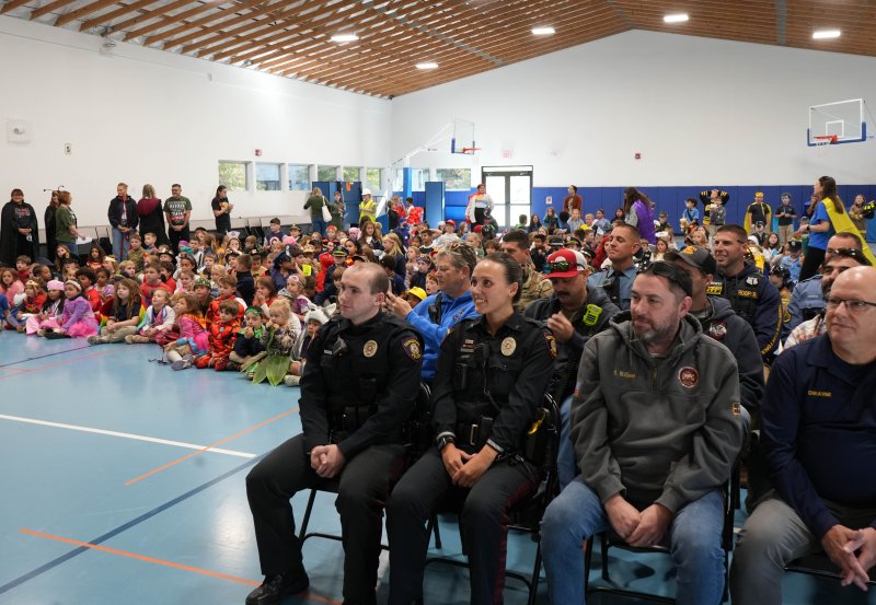 Local first responders and costumed students are ready for the school’s pumpkin-decorating contest winner to be announced at the Halloween Community Hero Day.