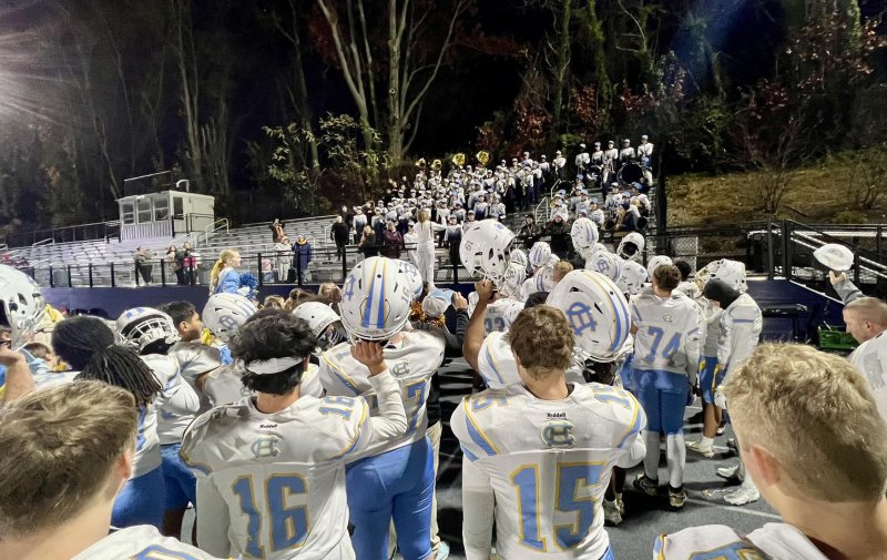 The Cape team sings the Cape Henlopen alma mater with the band after the loss to Sallies.