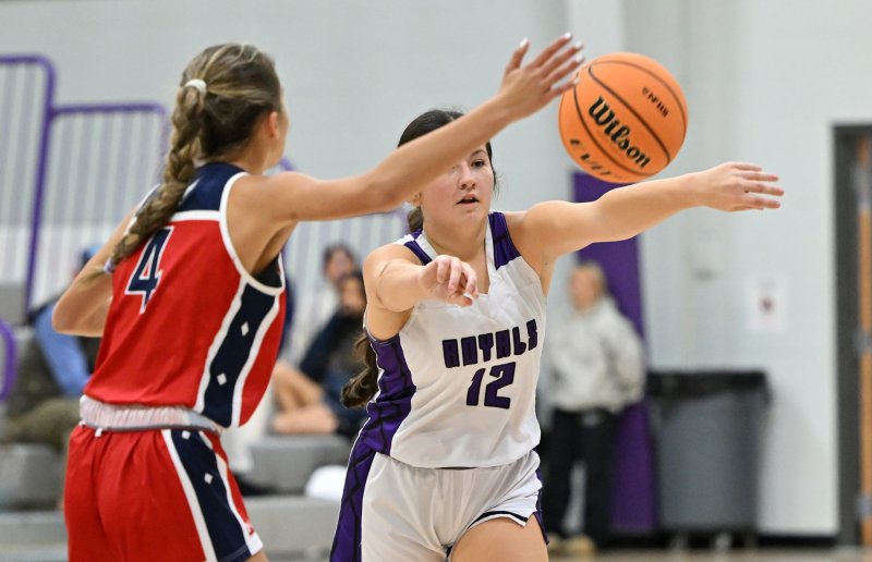 Royals player MaryKate Dougherty passes down low through the Mallards’ Rani Yonker.