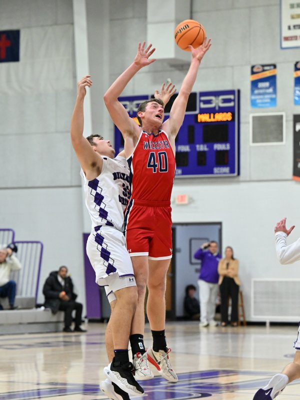 Mallards senior Ben Anthony, right, battles for a rebound with Royals senior Andrew Collins.