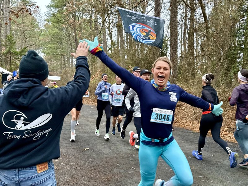 Jennifer Shultz of Lincoln University, Pa., has a great time running through Flag Alley along the Junction & Breakwater Trail during the half-marathon. SUBMITTED PHOTO