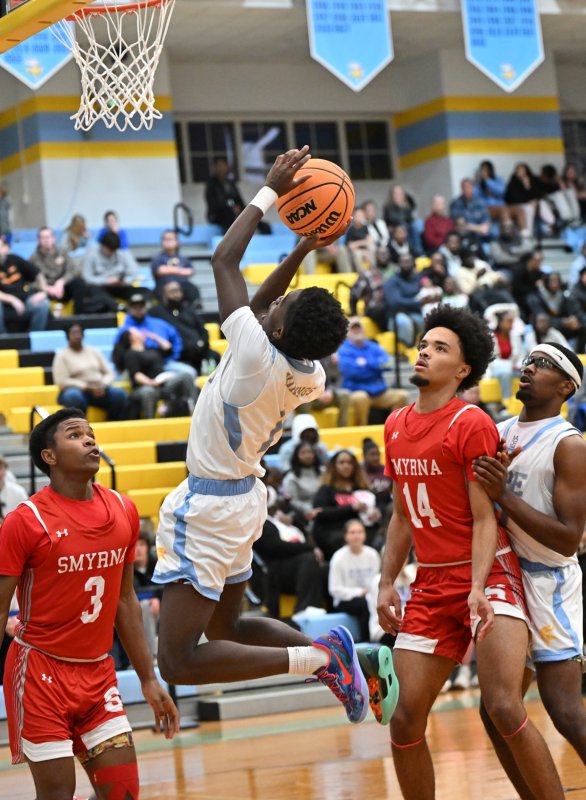 Cape junior point guard Stephen Sivels makes a twisting shot.