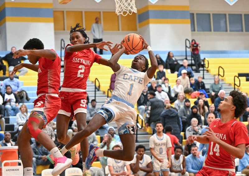 Cape junior point guard Stephen Sivels makes an acrobatic move to the hoop.