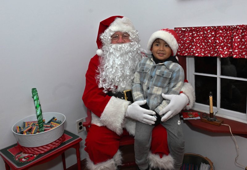 Kalelo Roblero Perez tells Santa what he wants for Christmas.