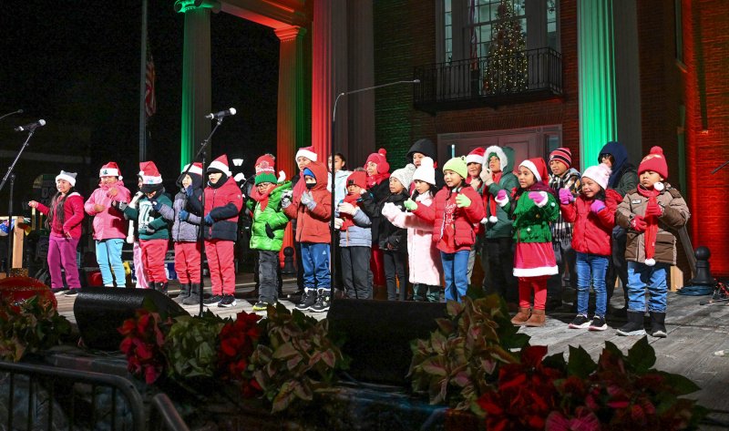 Singers from the children’s choir of St. Michael’s Catholic Church entertain the crowd with their Christmas song “Mi Burrito Sabanero.”