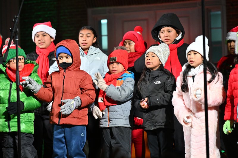 Singers from the children’s choir of St. Michael’s Catholic Church entertain the crowd with their Christmas song “Mi Burrito Sabanero.”