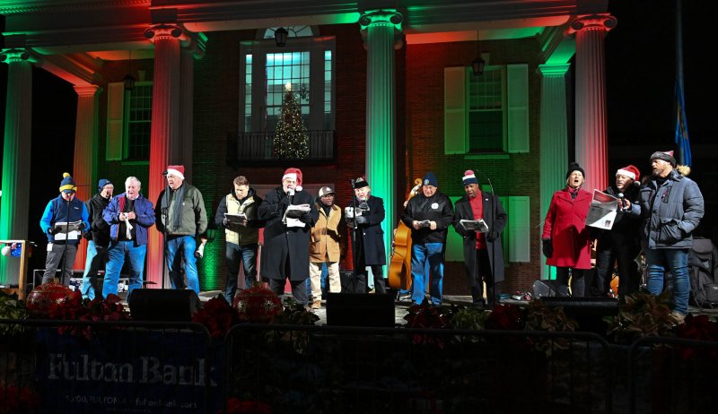 Local politicians and VIPs join Kevin Short and Ed Shockley to sing carols.