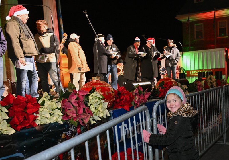 Emma Flickinger, 6, gets close to the singers.