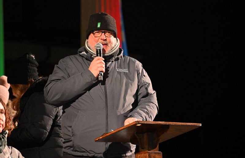 Parade emcee Kurt Herring offers information about each unit of the parade.