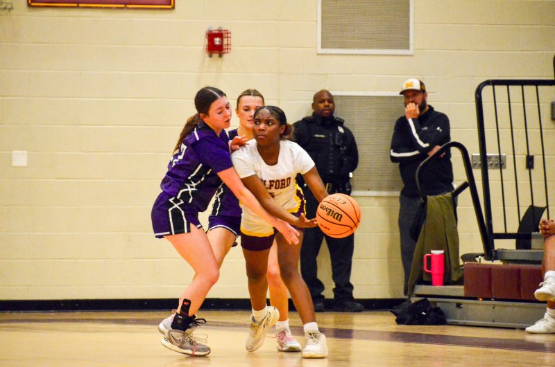 Royals sophomore Avery McCoy and senior Riley Barto team up against Amariah Satcher-Harris.