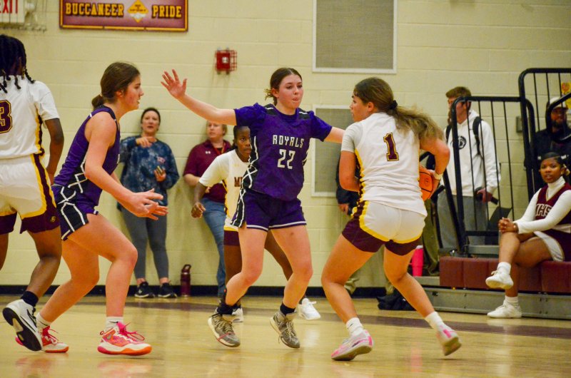 Royals sophomore Avery McCoy, left, gets help from senior Eve Bohinksi defending the perimeter.