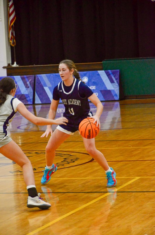 Sussex Academy sophomore Reilly Mobilia eyes up her defender.