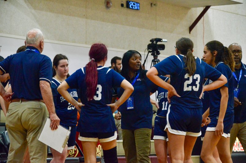 Seahawks coach Rayona Benson discusses strategy with her girls.
