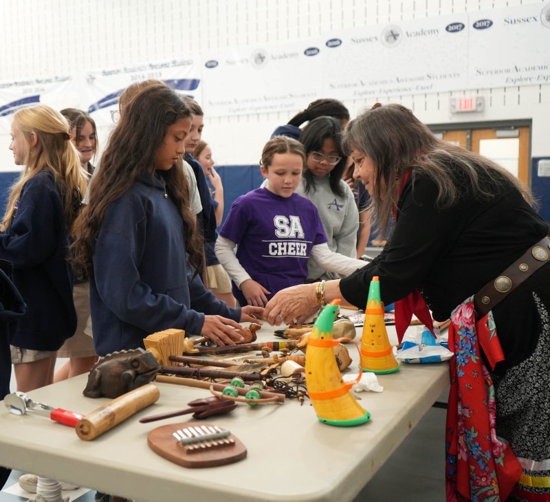 Boe Harris-Nakakakena, far right, shows Sussex Academy students various traditional musical instruments during her visit to campus Nov. 13. Watching are (l-r) Kay Samayoa-Gijalva, Zoe Sexton and Bianca Carmella Benito.
