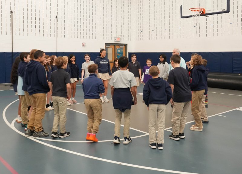Boe Harris-Nakakakena teaches students a traditional dance.