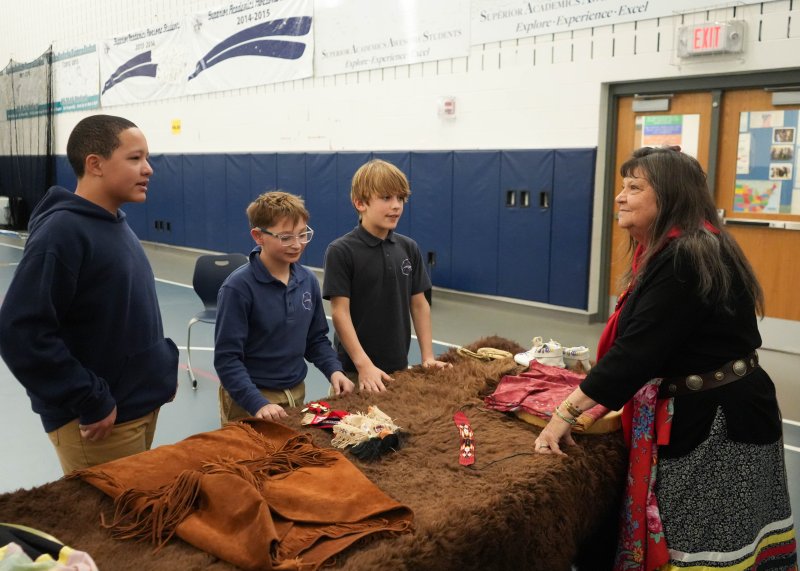 Boe Harris-Nakakakena, far right, answers students’ questions about several of the cultural artifacts that she brought in to display. The students are (l-r) Kallen Hayes, Nash Dondarski and Laurence Curry.