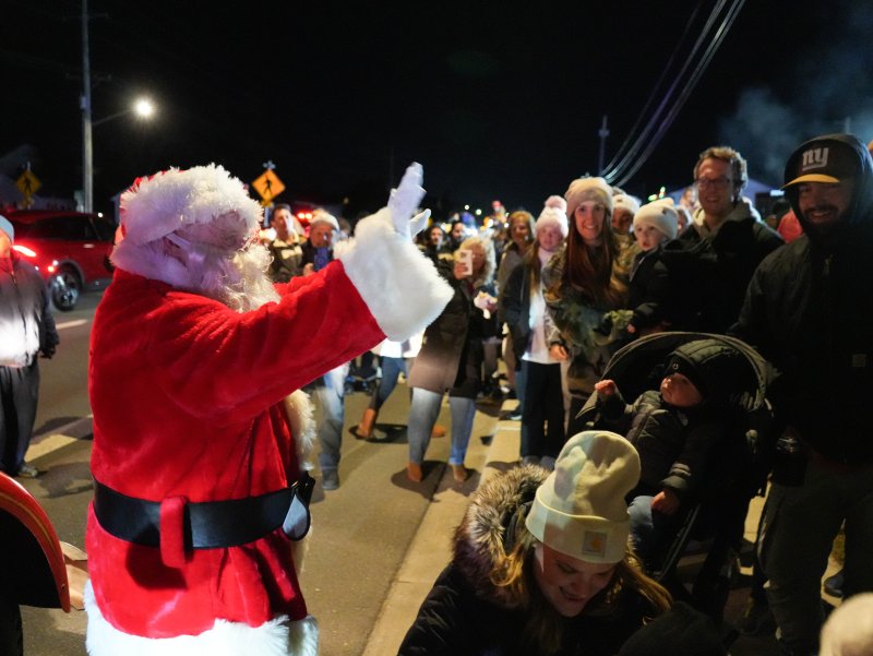 Santa Claus waves to an awaiting crowd at the Fifer’s Christmas tree-lighting in Dewey Beach on Nov. 29.