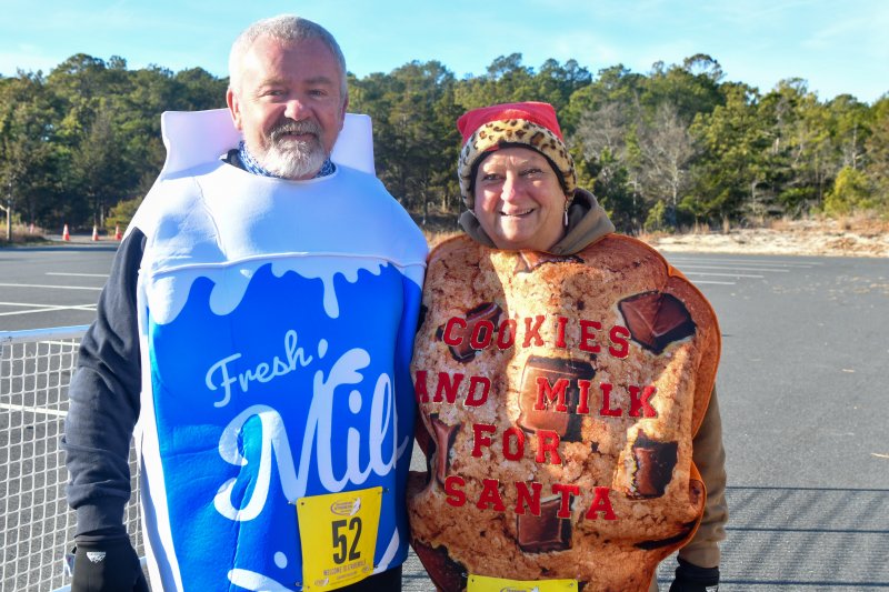 Kevin and Laurie Milnes are milk and cookies for the Run With Santa 5K at Cape Henlopen State Park in Lewes. DAVE FREDERICK PHOTOS