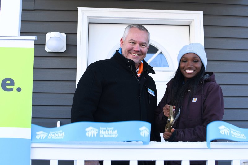 Cutting the ribbon on her new home is Shamaya Brown, right, alongside Kevin Gilmore, Sussex County Habitat for Humanity CEO. SUBMITTED PHOTO