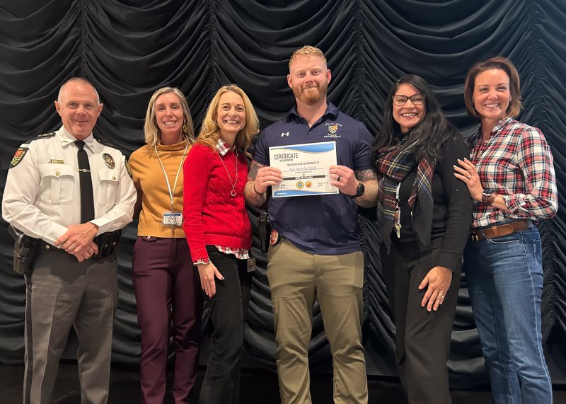 Cpl. Nick Yatsko, school resources officer, receives the Cape district’s Going the Extra Mile staff award for Frederick D. Thomas Middle School. Shown are (l-r) Lewes Police Chief Tom Spell; Meghan Catts, assistant principal; Dr. Jenny Nauman, superintendent; Yatsko; Elyse Baerga, principal; and Alison Myers, school board president. SUBMITTED PHOTOS