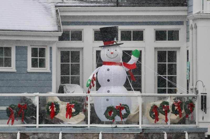 A big snowman welcomes wintry weather from its perch atop a house on Silver Lake. BILL SHULL PHOTO