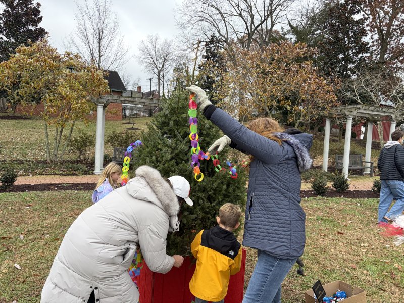 Students and parents from Milton Elementary School decorate the tree.