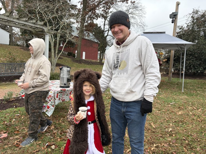 Lance and Adeline Hickman enjoy some hot chocolate in the cold during the Christmas tree decoration.
