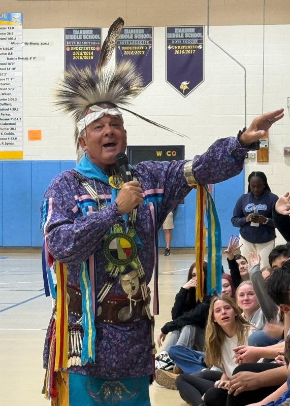Michael Harmon interacts with the crowd during the assembly.