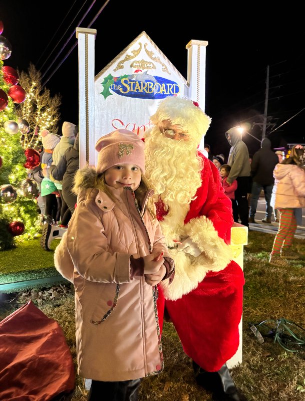 Ainsley Skarda meets Santa Claus at the Fifer’s Farm Kitchen tree-lighting in Dewey Beach Nov. 29.