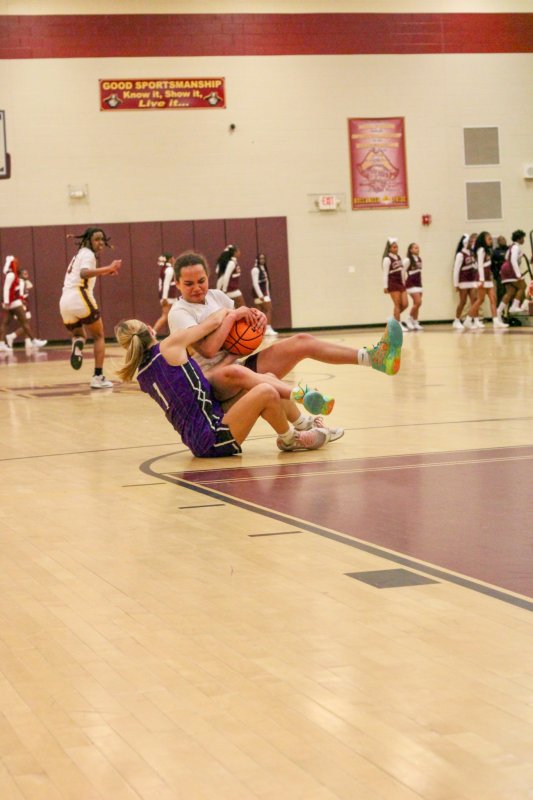 Delmarva Christian senior Riley Barto and Milford junior Bella Watson fight for a loose ball.
