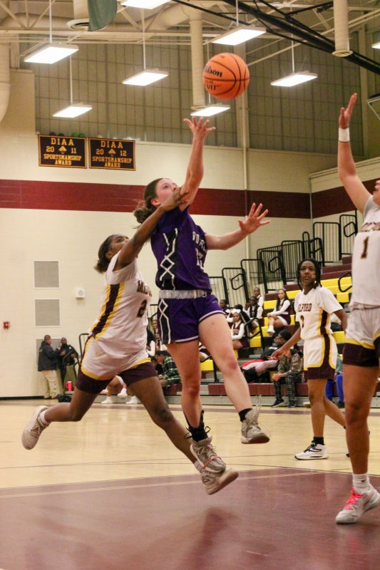 Delmarva Christian sophomore Avery McCoy tries to finish through traffic.