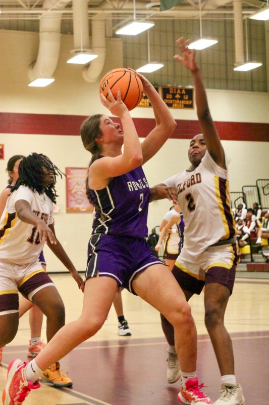 Royals senior Eve Bohinski tries to get over Milford freshman Kayln Piper-Evans.
